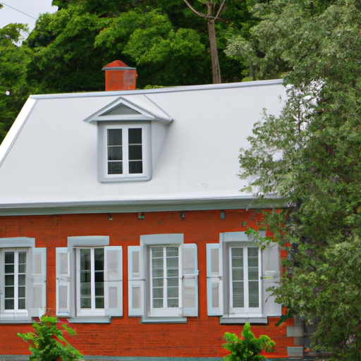 A red brick house with white shutters and a grey roof surrounded by green trees